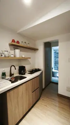 a kitchen with a sink and a counter top at Hermoso apartaestudio Zona Rosa de Milan in Manizales