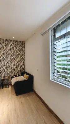 a room with a bed and a window at Hermoso apartaestudio Zona Rosa de Milan in Manizales
