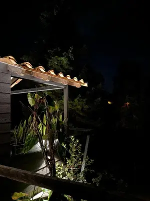 a house with a gazebo at night with a plant at Cabañas Tahamí con jacuzzi cerca al Aeropuerto in Guarne
