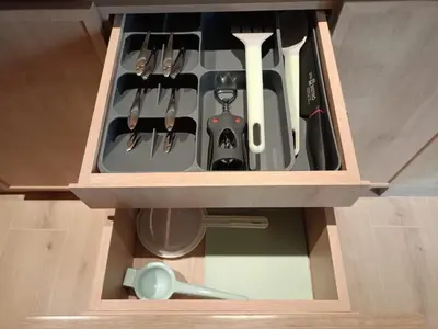 a wooden drawer filled with utensils in a kitchen at Casa Tokyo Manila By Xcay Home in Medellín