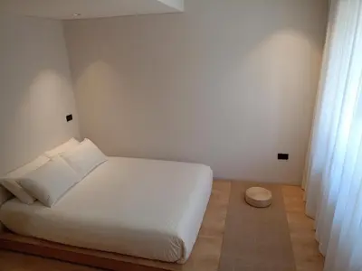 a white bedroom with a white bed and curtains at Casa Tokyo Manila By Xcay Home in Medellín