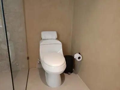 a bathroom with a toilet and a roll of toilet paper at Casa Tokyo Manila By Xcay Home in Medellín