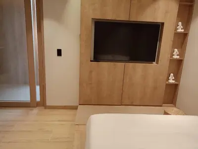 a living room with a flat screen tv on a wall at Casa Tokyo Manila By Xcay Home in Medellín