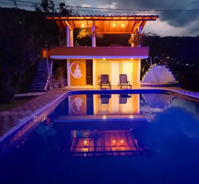 a house with a swimming pool at night at Casa Finca Minas in Estación Angelópolis