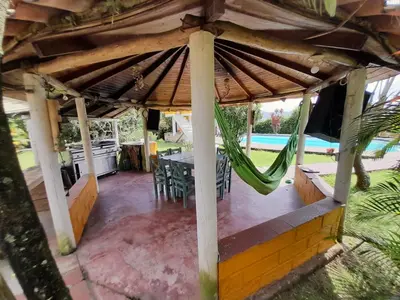 a patio with a table and a hammock at Casa Finca Minas in Estación Angelópolis