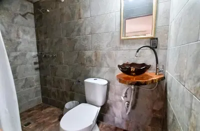a bathroom with a toilet and a sink at Casa Finca Minas in Estación Angelópolis
