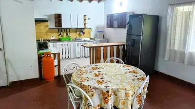 a kitchen with a table and a refrigerator at Casa Finca Minas in Estación Angelópolis