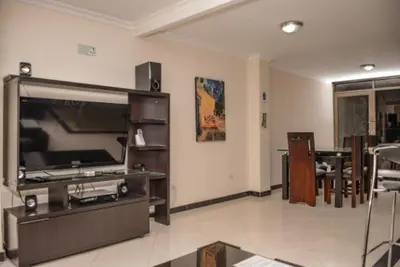 a living room with a flat screen tv and a couch at Poblado medellin cll8 101 in Medellín