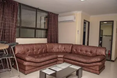 a brown leather couch in a living room at Poblado medellin cll8 101 in Medellín