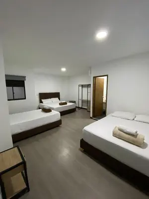 a bedroom with two beds and a room with at Hotel Gallery By 70 in Medellín