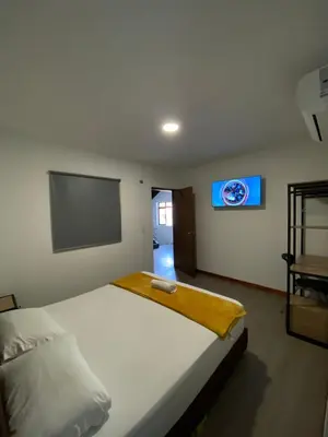 a bedroom with a bed and a flat screen tv at Hotel Gallery By 70 in Medellín