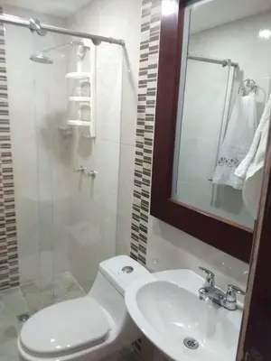 a bathroom with a toilet and a sink and a mirror at Habitacion confortable 1 persona in Medellín