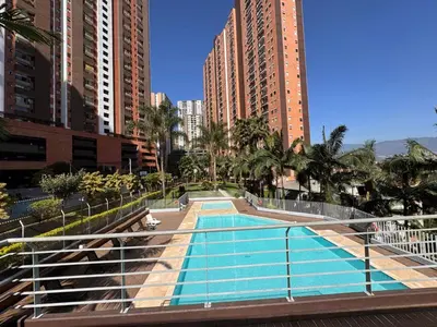 a swimming pool in a city with tall buildings at Habitacion confortable 1 persona in Medellín