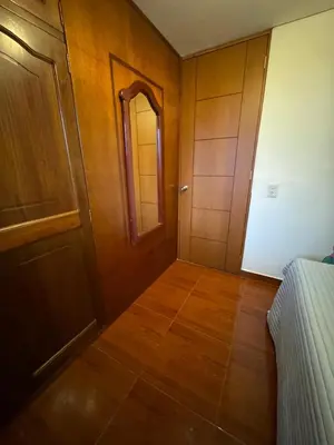 a room with a hallway with a door and a mirror at Habitacion confortable 1 persona in Medellín