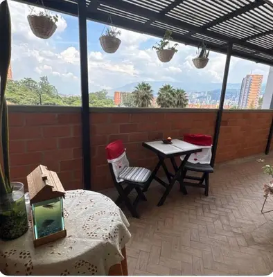 a patio with a table and chairs on a brick wall at Habitacion confortable 1 persona in Medellín