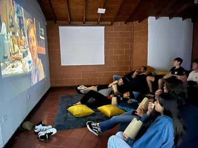 a group of people sitting in a room reading books at Kyra Sol Cinehome El Carmen Carmen de Viboral Cerca al Centro in Carmen de Viboral