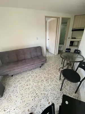 a living room with a couch and a table at Loft Céntrico en Medellín Plaza Mayor y Parking 309 in Medellín