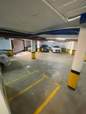 a parking garage with two cars parked in it at Loft Céntrico en Medellín Plaza Mayor y Parking 309 in Medellín