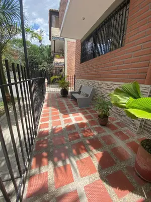 a patio with a chair on the side of a building at Loft Céntrico en Medellín Plaza Mayor y Parking 309 in Medellín