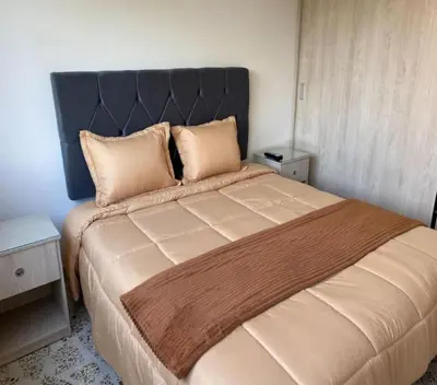 a bedroom with a large bed with a black headboard at Loft Céntrico en Medellín Plaza Mayor y Parking 309 in Medellín