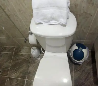a white toilet in a bathroom with towels on it at Céntrico Familiar Vive y disfruta Medellín 107 in Medellín