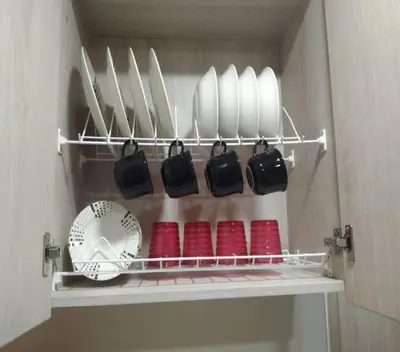 a shelf with plates and utensils in a kitchen at Céntrico Familiar Vive y disfruta Medellín 107 in Medellín