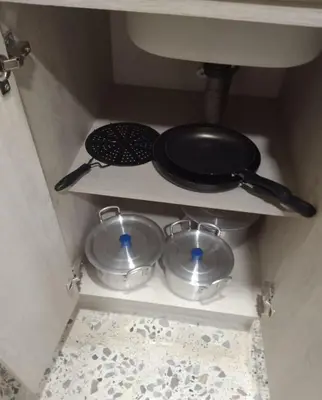 a kitchen with two pans and a skillet on a shelf at Céntrico Familiar Vive y disfruta Medellín 107 in Medellín