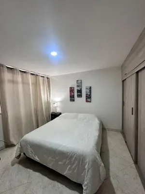 a bedroom with a large white bed in it at Habitación en apto duplex baño compartido, piso 5 sin ascensor in Envigado