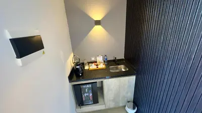 a bathroom with a sink and a counter with a light at Rooca Habitat Guatape in Guatapé