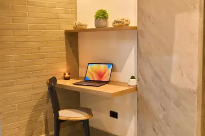 a desk with a laptop computer on a shelf at Cozy Aparta-Suite Stadio Rosa Negra in Medellín