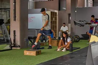 a group of people in a gym with a man playing soccer at Cozy Aparta-Suite Stadio Rosa Negra in Medellín