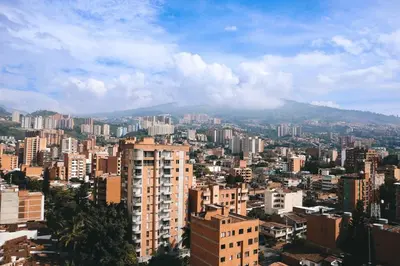 a city with buildings and a mountain in the background at Cozy Aparta-Suite Stadio Rosa Negra in Medellín