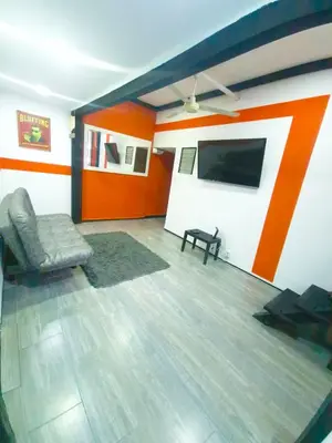 a living room with a couch and a flat screen tv at Sunset Strip Suite # 301C ICON Lleras Park 301 in Medellín