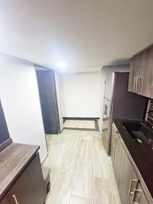 a small kitchen with wooden floors in a room at Sunset Strip Suite # 301C ICON Lleras Park 301 in Medellín
