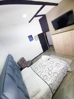 a living room with a couch and a flat screen tv at Sunset Strip Suite # 301C ICON Lleras Park 301 in Medellín
