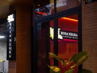 a window of a restaurant with a plant in front of it at Charming Aparta-Suite Stadio Rosa Negra Retreat in Medellín