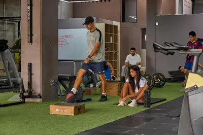 a group of people in a gym with a man playing soccer at Charming Aparta-Suite Stadio Rosa Negra Retreat in Medellín