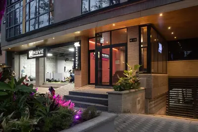 a store front of a building with plants and flowers at Cozy Aparta-Suite Stadio Jacuzzi Rosa Negra in Medellín