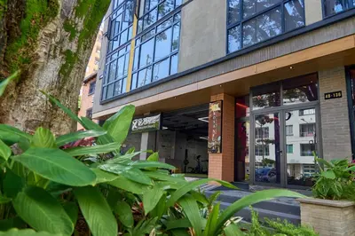 a building with plants in front of it at Rosa Negra Haven Cozy Stadio Aparta-Suite in Medellín