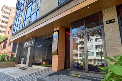 a store front of a building with glass windows at Comfortable Stadio Suite Rosa Negra in Medellín