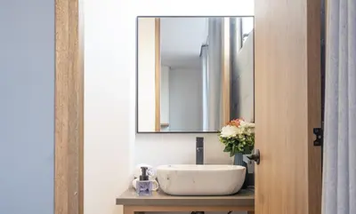 a bathroom with a sink and a mirror at Stadio Serenity Rosa Negra Aparta-Suite in Medellín