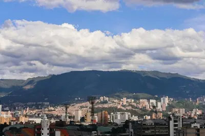 a view of a city with mountains in the background at Stadio Serenity Rosa Negra Aparta-Suite in Medellín