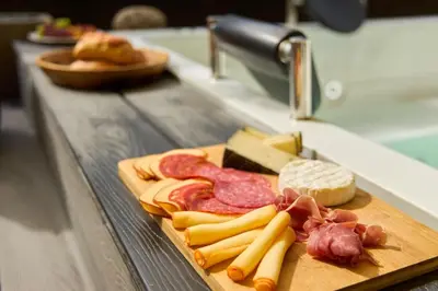 a cutting board with meats and cheese on a counter at Elegant Cozy Suite Rosa Negra Stadio in Medellín