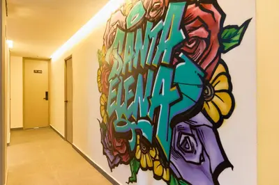 a mural of a person with butterflies on a wall at Elegant Cozy Suite Rosa Negra Stadio in Medellín
