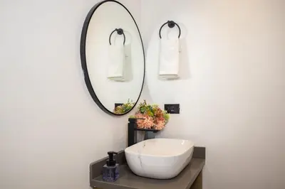 a bathroom with a white sink and a mirror at Cozy Comfort at Rosa Negra Stadio Suite in Medellín