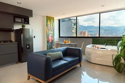 a living room with a couch and a bath tub at Jacuzzi Retreat Cozy Aparta-Suite Rosa Negra in Medellín