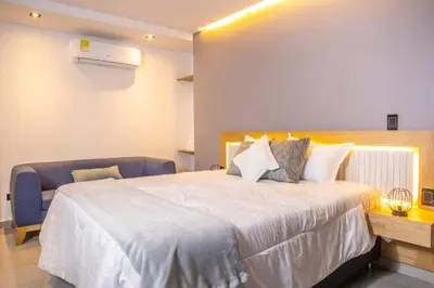 a bedroom with a large white bed in a room at Chic and Cozy Stadio Suite Rosa Negra in Medellín