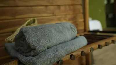 a pile of towels sitting on a table in front of a mirror at Montés Samaná in San Carlos