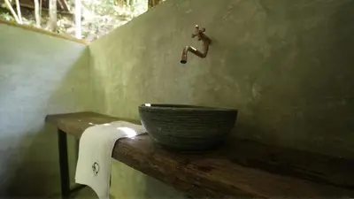 a person jumping in the air over a bowl in a bathroom at Montés Samaná in San Carlos