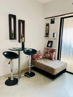 a living room with a couch and a table at Acogedor y Cómodo Estadio Laureles in Medellín
